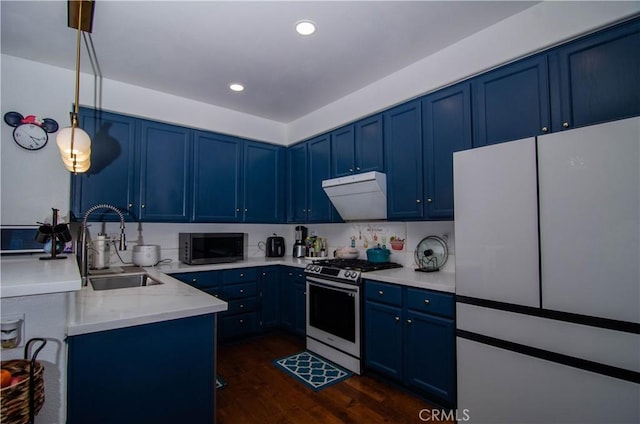 kitchen with ventilation hood, sink, white fridge, stainless steel gas stove, and pendant lighting