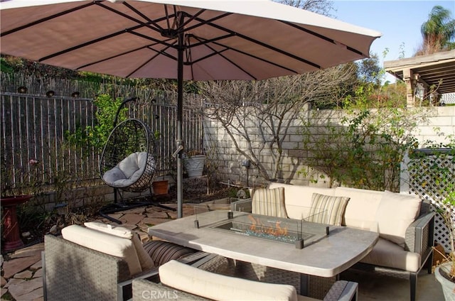 view of patio featuring an outdoor living space with a fire pit