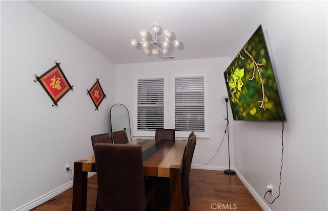 dining area featuring an inviting chandelier and dark hardwood / wood-style flooring