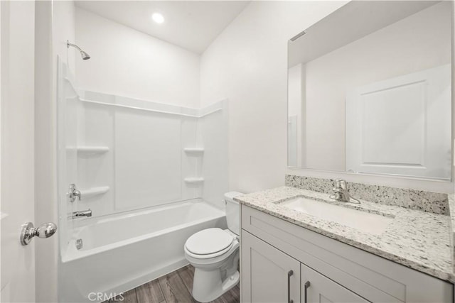 full bathroom featuring wood-type flooring, bathtub / shower combination, vanity, and toilet