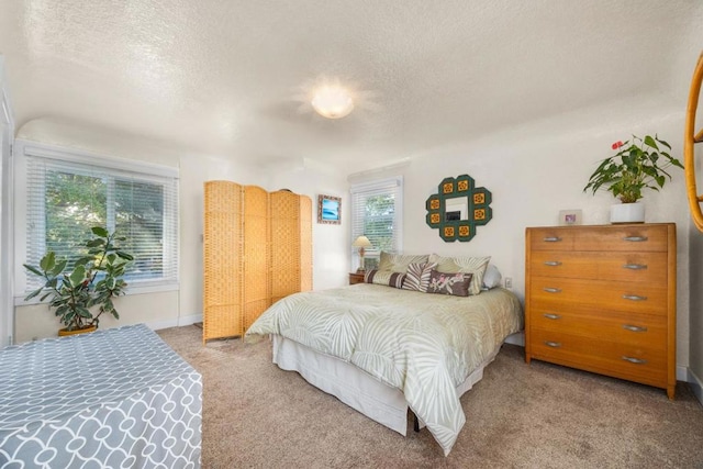 bedroom featuring a textured ceiling and carpet