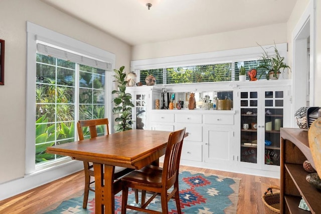 dining space with light hardwood / wood-style flooring