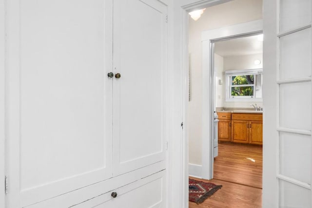 hall featuring hardwood / wood-style flooring and sink