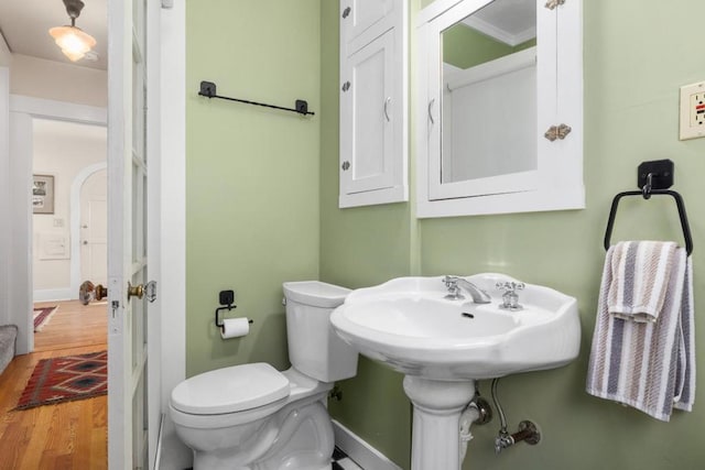 bathroom with hardwood / wood-style floors and toilet