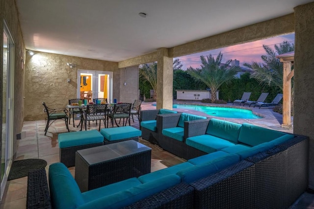 patio terrace at dusk featuring an outdoor living space