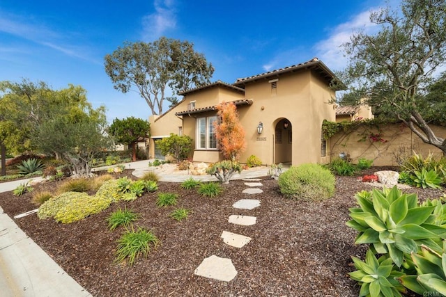 mediterranean / spanish house featuring a garage