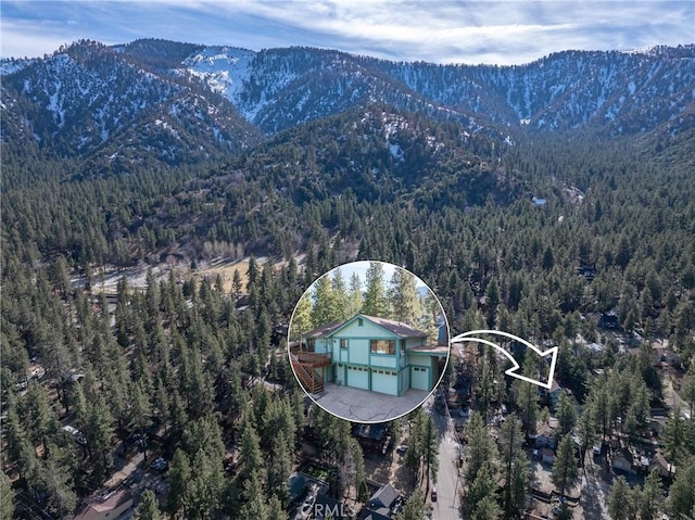 aerial view with a forest view and a mountain view