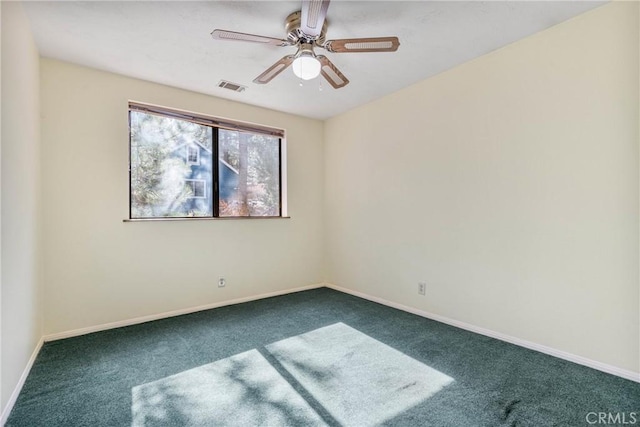 empty room featuring carpet floors, a ceiling fan, visible vents, and baseboards