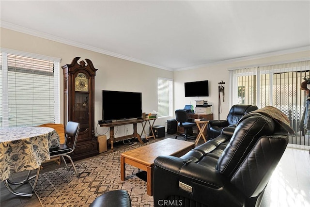 living room featuring plenty of natural light, ornamental molding, and wood-type flooring