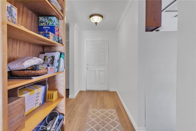 interior space featuring crown molding and light hardwood / wood-style floors