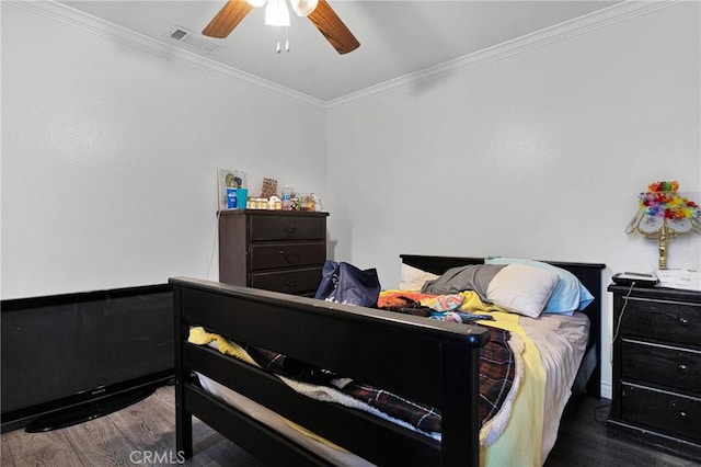 bedroom featuring ceiling fan, ornamental molding, and dark hardwood / wood-style floors