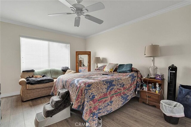 bedroom with crown molding, ceiling fan, and hardwood / wood-style floors