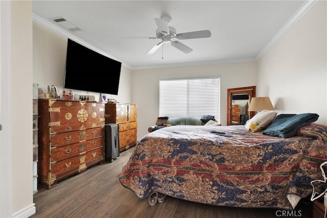 bedroom featuring hardwood / wood-style flooring, ornamental molding, and ceiling fan