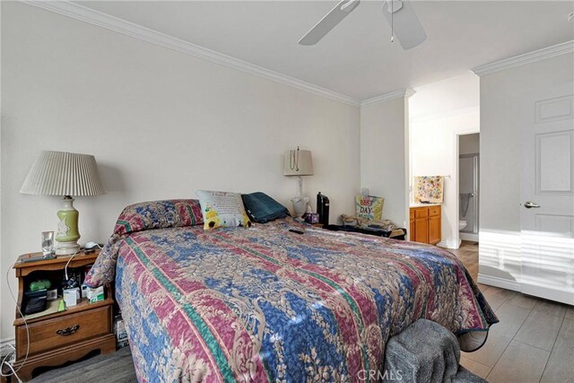 bedroom featuring crown molding, ensuite bath, ceiling fan, and light wood-type flooring