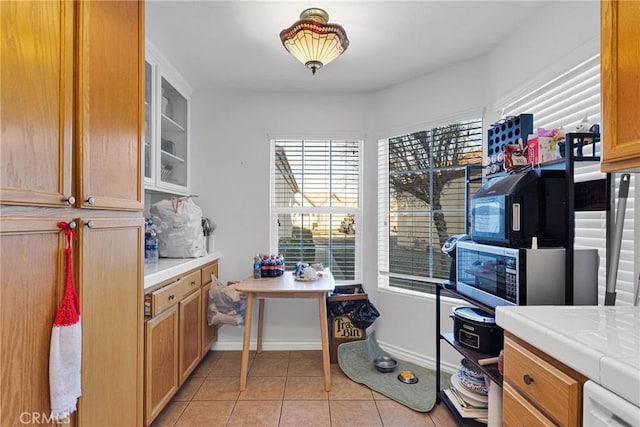 kitchen featuring tile counters, dishwasher, and light tile patterned floors