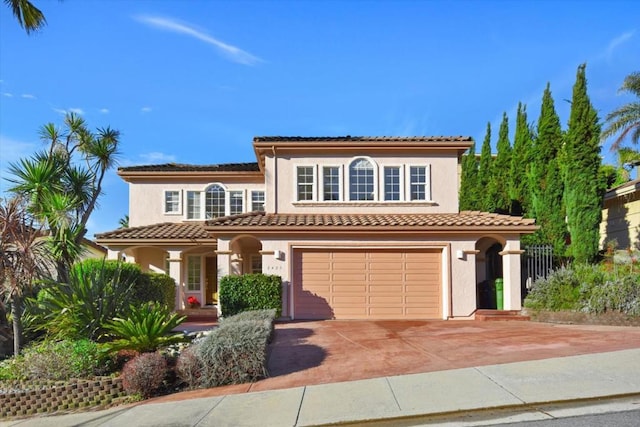 mediterranean / spanish house with a garage