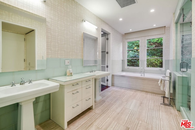 bathroom featuring sink and separate shower and tub