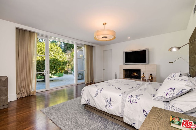 bedroom featuring dark wood-type flooring and access to exterior