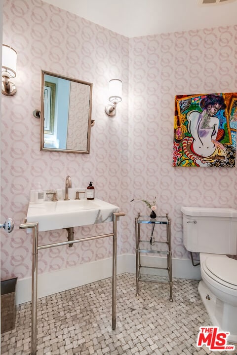 bathroom featuring tile patterned floors, toilet, and sink