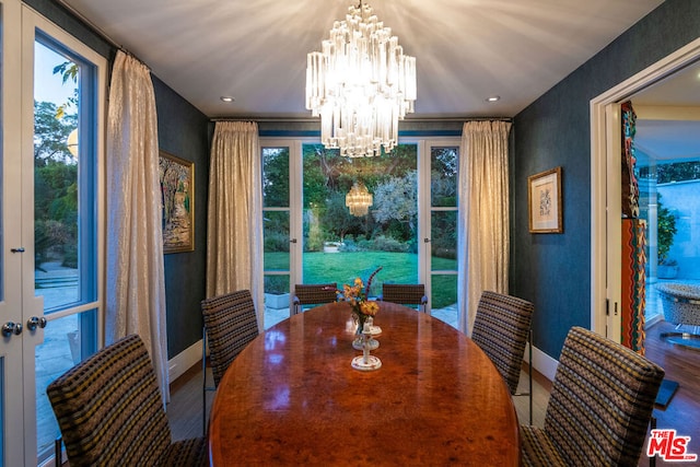 dining room featuring french doors, hardwood / wood-style flooring, and a notable chandelier