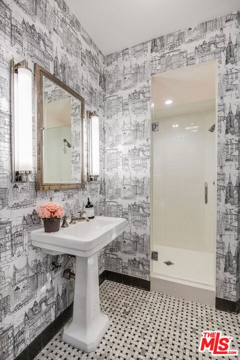 bathroom with a shower with door, tile patterned floors, and water heater