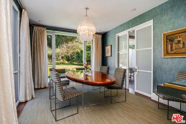 dining area featuring hardwood / wood-style flooring and a chandelier