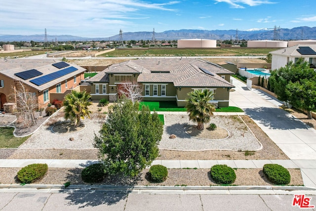 birds eye view of property with a mountain view