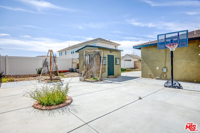 exterior space featuring a storage shed and a patio area