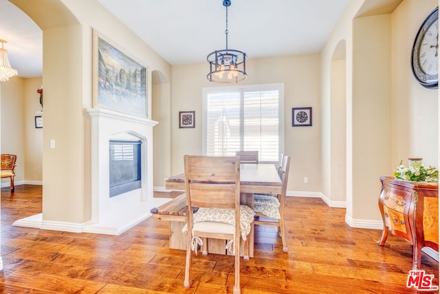 dining area featuring light hardwood / wood-style floors and a notable chandelier