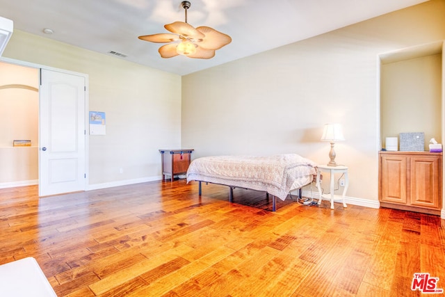 bedroom featuring hardwood / wood-style flooring and ceiling fan