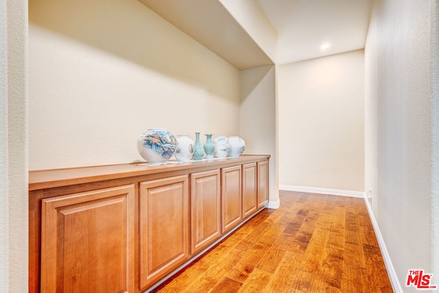 hallway with light hardwood / wood-style flooring