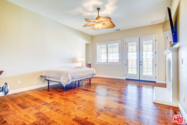 bedroom with french doors, ceiling fan, wood-type flooring, and access to outside