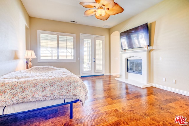 bedroom featuring french doors, access to exterior, ceiling fan, and light hardwood / wood-style flooring