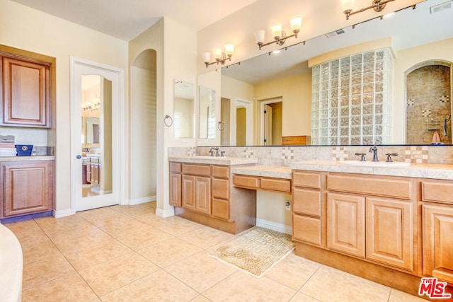 bathroom featuring vanity, backsplash, and tile patterned floors