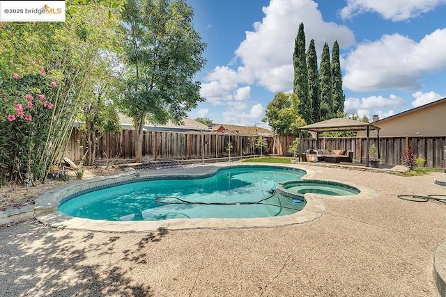 view of pool featuring a gazebo, an in ground hot tub, an outdoor hangout area, and a patio