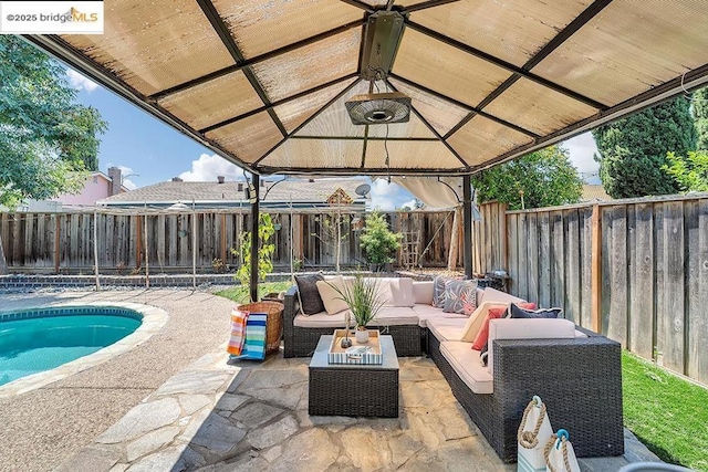 view of patio / terrace featuring an outdoor living space, a gazebo, and a fenced in pool