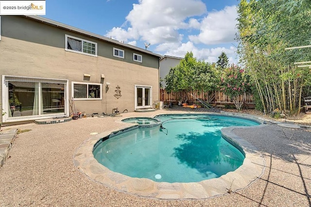 view of pool with an in ground hot tub and a patio