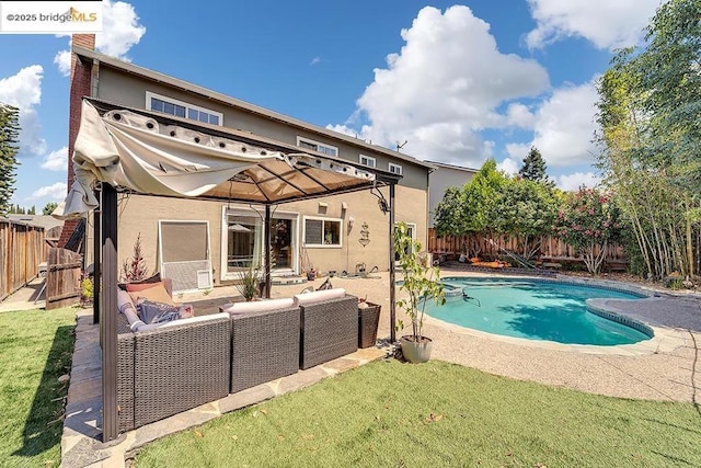 view of pool featuring an outdoor living space, a patio area, and a lawn