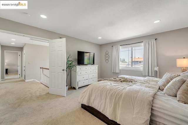 bedroom featuring light carpet