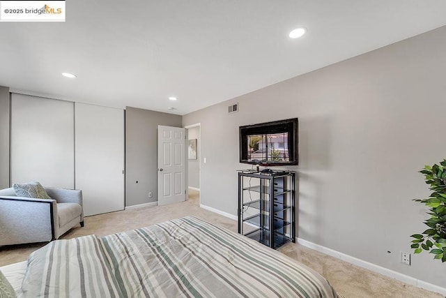 carpeted bedroom with a closet