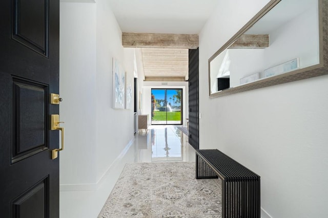 hallway featuring beam ceiling