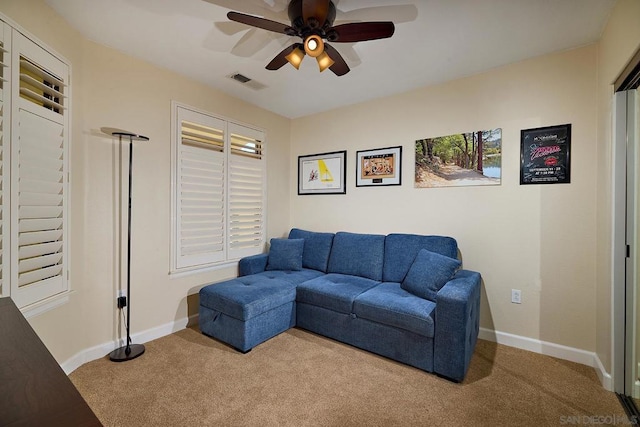 living room with light colored carpet and ceiling fan