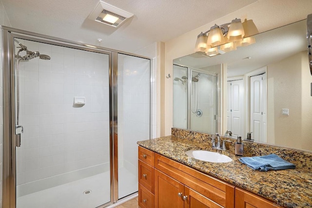 bathroom with vanity and a shower with shower door