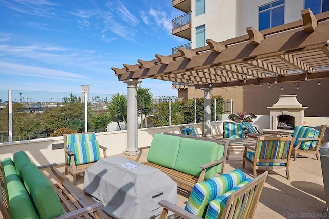 view of patio / terrace with a pergola, grilling area, and an outdoor living space with a fireplace