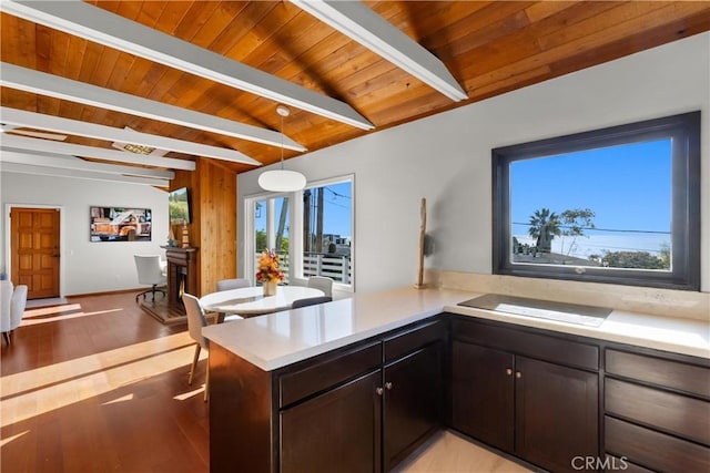 kitchen featuring wood ceiling, decorative light fixtures, kitchen peninsula, and beam ceiling