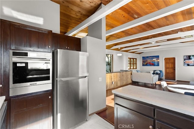 31955 10th Ave, Laguna Beach, CA 92651 - kitchen with stainless steel appliances, wood ceiling with exposed beams, dark brown cabinetry, light countertops, and open floor plan