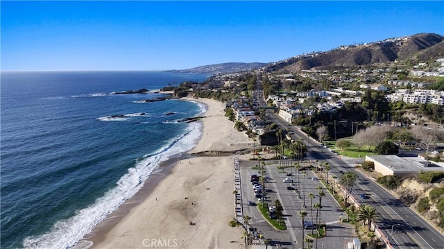 aerial view featuring a water and mountain view and a beach view