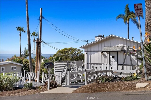 31955 10th Ave, Laguna Beach, CA 92651 - view of front of house featuring a chimney and board and batten siding