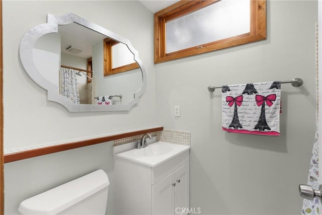 31955 10th Ave, Laguna Beach, CA 92651 - bathroom featuring decorative backsplash, vanity, and toilet