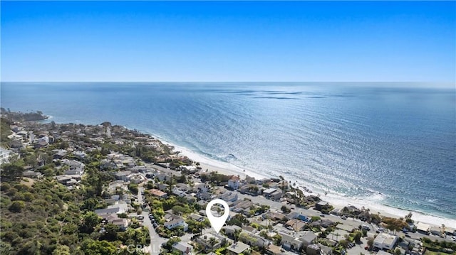 drone / aerial view featuring a beach view and a water view